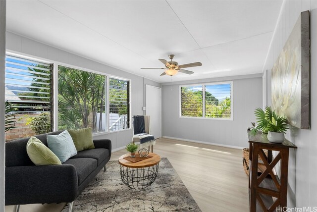 living room with light hardwood / wood-style floors and ceiling fan