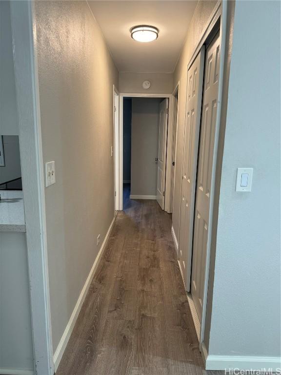 hall with dark hardwood / wood-style flooring