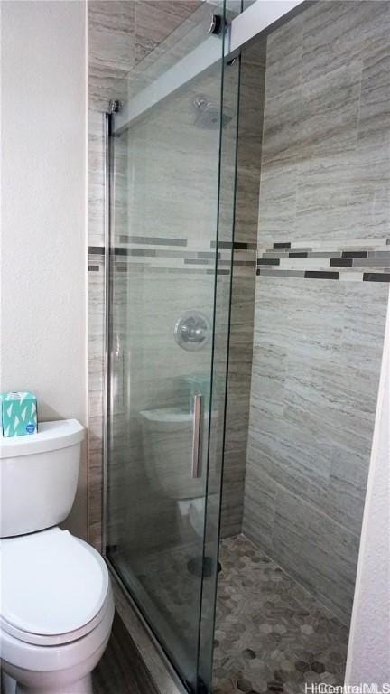 bathroom with toilet and walk in shower