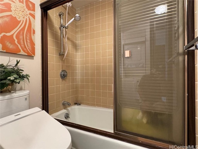 bathroom featuring toilet and enclosed tub / shower combo