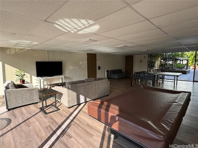 dining room with wood-type flooring and a paneled ceiling