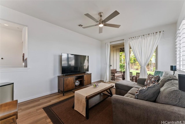 living room with ceiling fan and light hardwood / wood-style floors