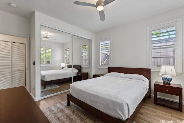 bedroom featuring light hardwood / wood-style flooring, a closet, and ceiling fan