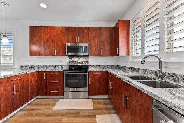 kitchen with a wealth of natural light, light wood-type flooring, and appliances with stainless steel finishes