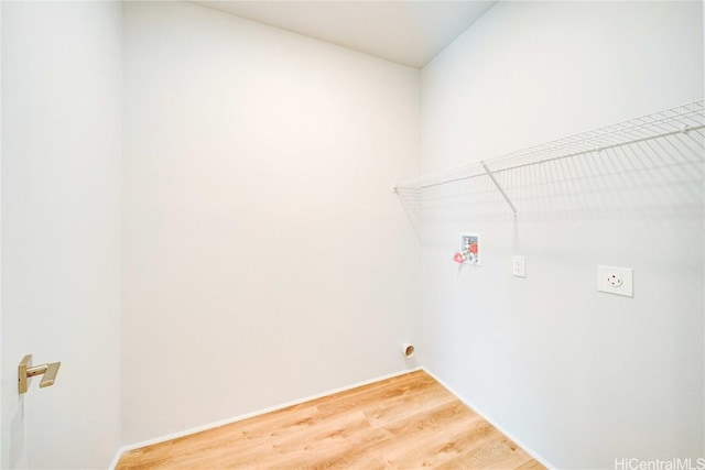 laundry room with electric dryer hookup, hardwood / wood-style floors, and washer hookup