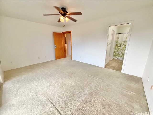 unfurnished bedroom with ensuite bathroom, ceiling fan, and light colored carpet