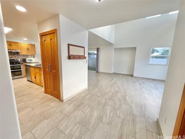 kitchen with decorative backsplash, appliances with stainless steel finishes, and plenty of natural light