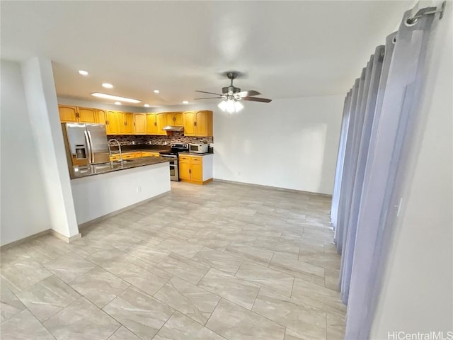 kitchen featuring light brown cabinets, sink, ceiling fan, tasteful backsplash, and stainless steel appliances