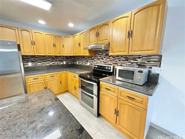 kitchen featuring backsplash, dark stone counters, and stainless steel appliances