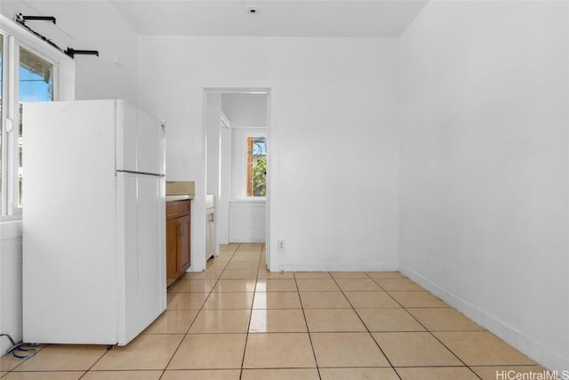 kitchen featuring light tile patterned flooring and white refrigerator