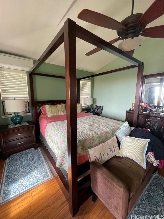 bedroom featuring hardwood / wood-style floors, ceiling fan, and lofted ceiling