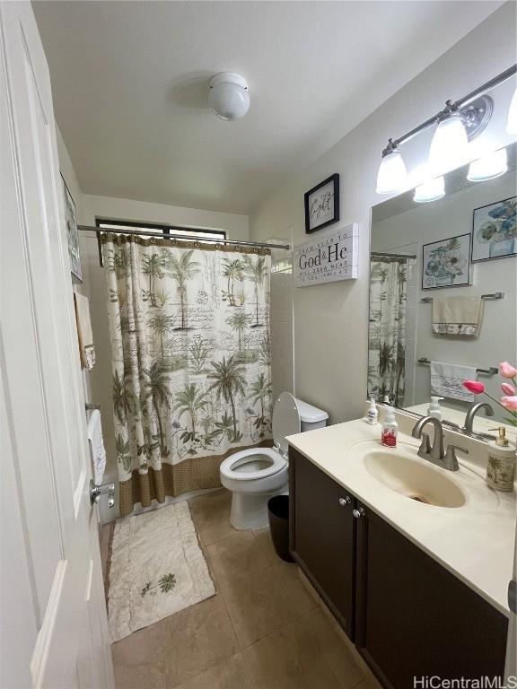 bathroom featuring tile patterned floors, vanity, and toilet