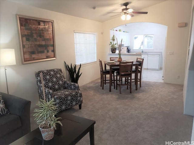 carpeted dining space featuring ceiling fan