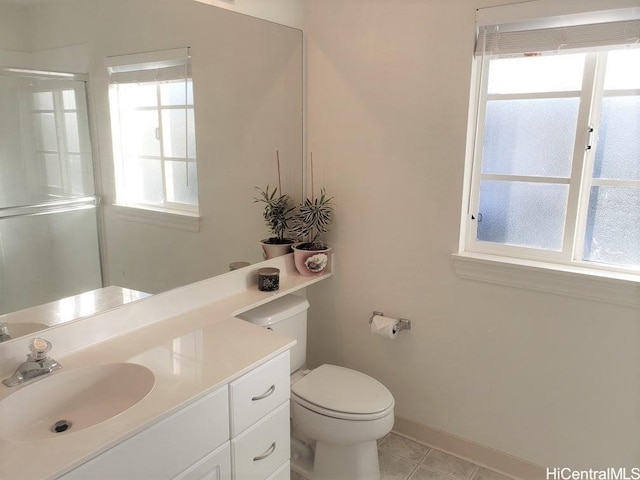 bathroom with tile patterned flooring, toilet, a wealth of natural light, and an enclosed shower