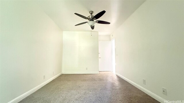 spare room with ceiling fan and carpet