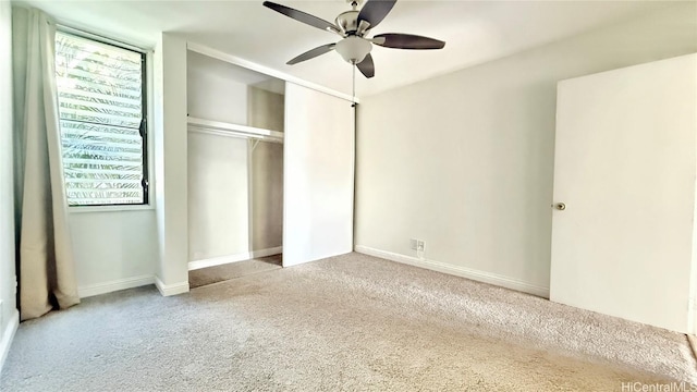 unfurnished bedroom with carpet, ceiling fan, and multiple windows