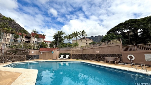 view of swimming pool featuring a mountain view