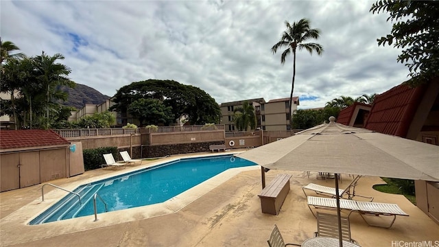 view of swimming pool featuring a mountain view and a patio area