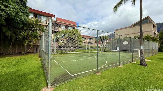 view of basketball court featuring a yard