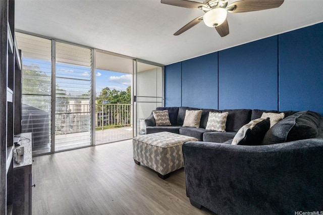 95-2031 Waikalani Pl Unit D906, Mililani, HI 96789 - living area featuring a wall of windows, wood finished floors, ceiling fan, and a decorative wall