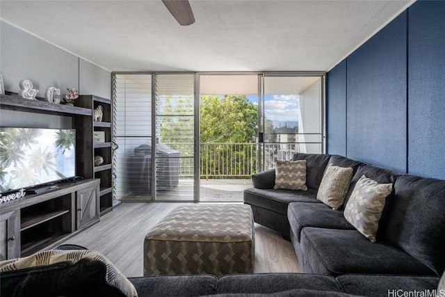 living room featuring floor to ceiling windows, ceiling fan, and hardwood / wood-style flooring