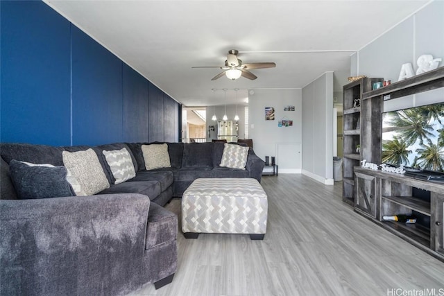 living room with ceiling fan and hardwood / wood-style flooring