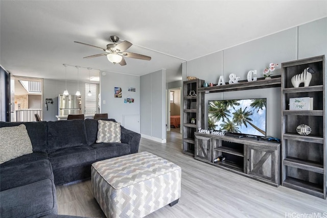 living room featuring hardwood / wood-style flooring and ceiling fan