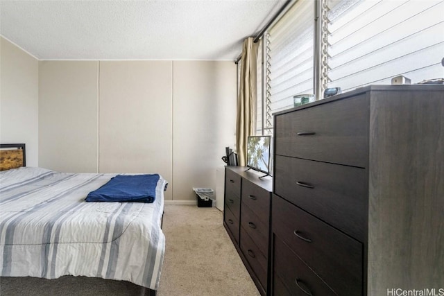 carpeted bedroom featuring a textured ceiling