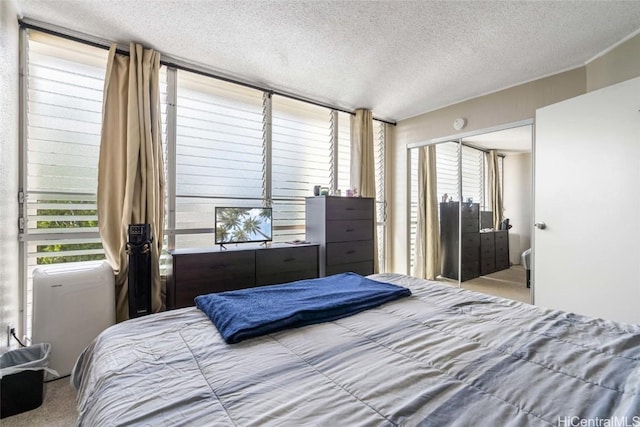 carpeted bedroom featuring a textured ceiling