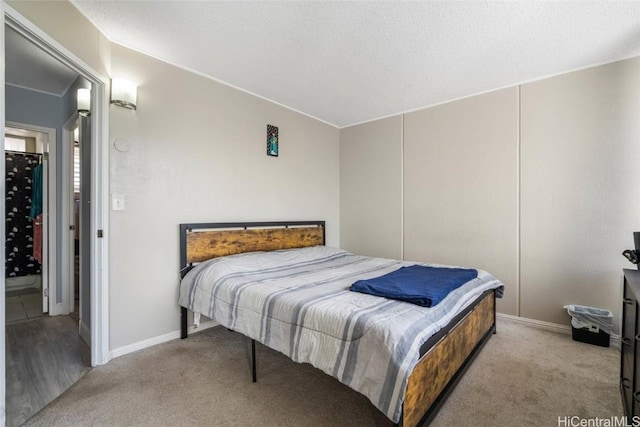 bedroom with light carpet and a textured ceiling