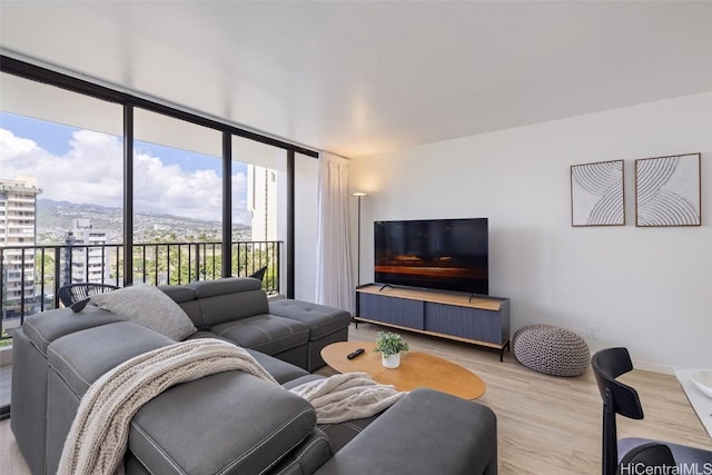 living area with a view of city and light wood-style floors