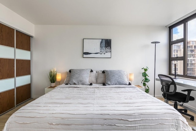 bedroom featuring light wood-style floors and a closet