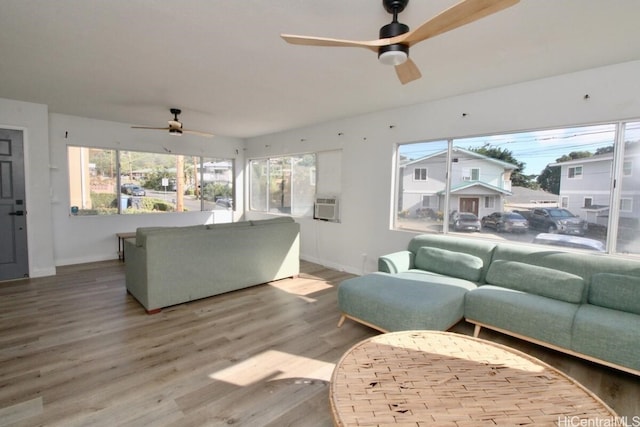 living room with hardwood / wood-style floors, ceiling fan, and cooling unit