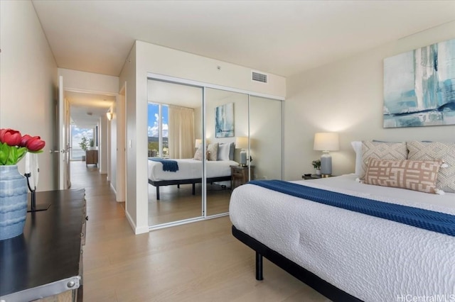 bedroom with hardwood / wood-style floors and a closet