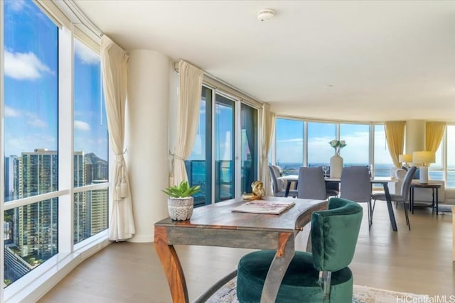 dining area featuring light hardwood / wood-style floors and a water view