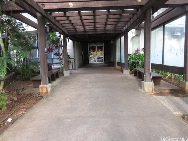 view of patio / terrace with a pergola and an AC wall unit