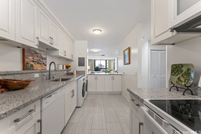 kitchen with white appliances, white cabinets, sink, light stone countertops, and washer / dryer