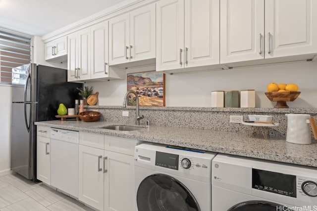 washroom with washing machine and dryer and sink