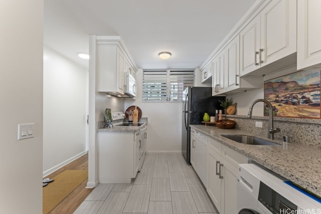 kitchen featuring white cabinets, washer / dryer, white appliances, and sink