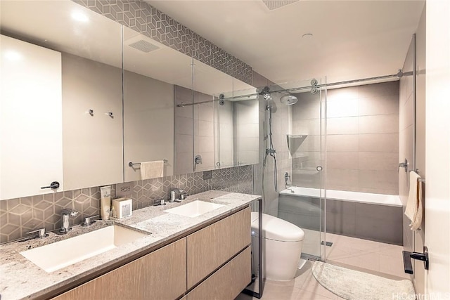 bathroom with toilet, vanity, tasteful backsplash, and tile patterned floors