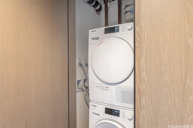 laundry room with stacked washer / dryer