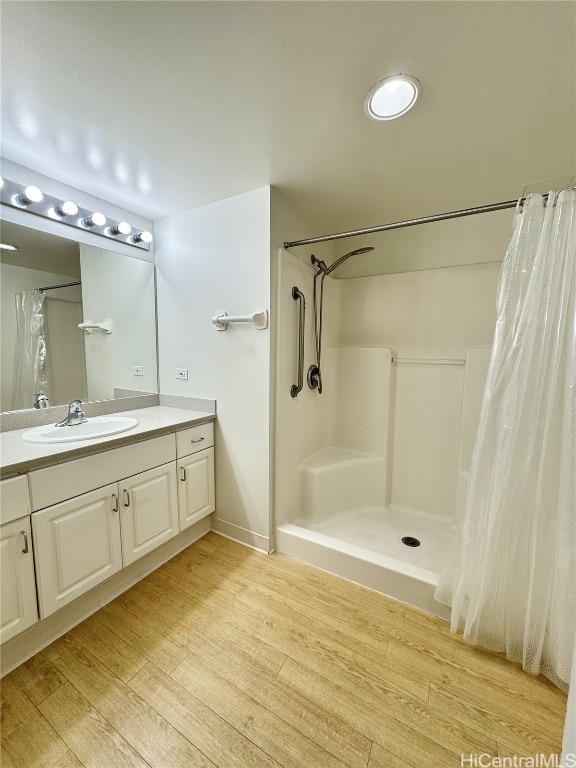 bathroom featuring a shower with curtain, vanity, and hardwood / wood-style flooring