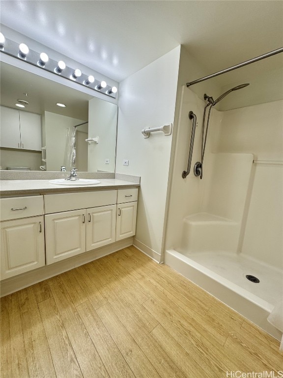 bathroom featuring hardwood / wood-style floors, vanity, and curtained shower