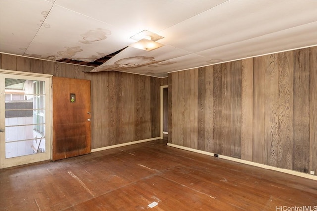 spare room featuring wood walls