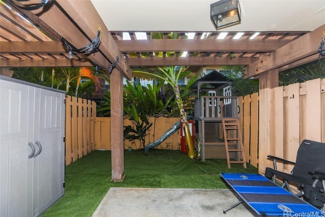 view of yard with a pergola and a playground