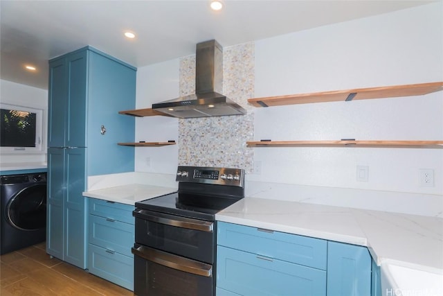 kitchen with washer / dryer, decorative backsplash, double oven range, light wood-type flooring, and wall chimney exhaust hood