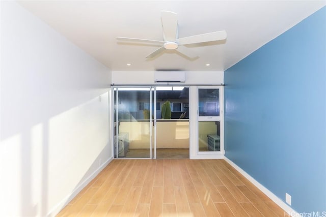 unfurnished bedroom featuring a closet, wood-type flooring, an AC wall unit, and ceiling fan