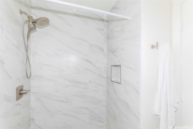 bathroom with a tile shower