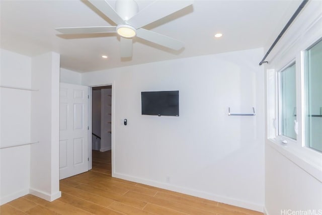 unfurnished room with ceiling fan and light hardwood / wood-style flooring