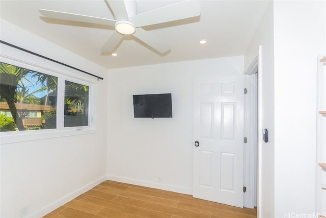 empty room with ceiling fan and light wood-type flooring